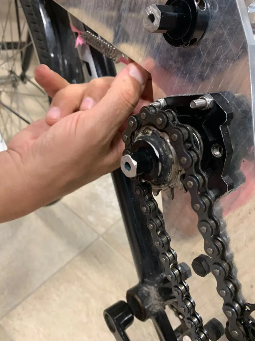 Hand adjusting the bicycle chain and clutch mechanism.