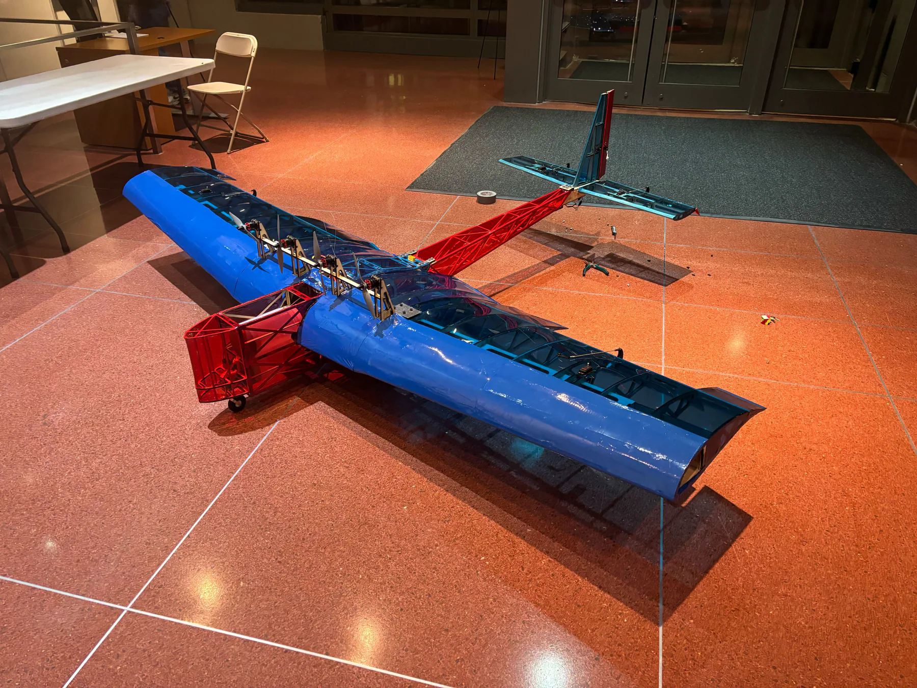 Completed blue and red Leviathan aircraft indoors.