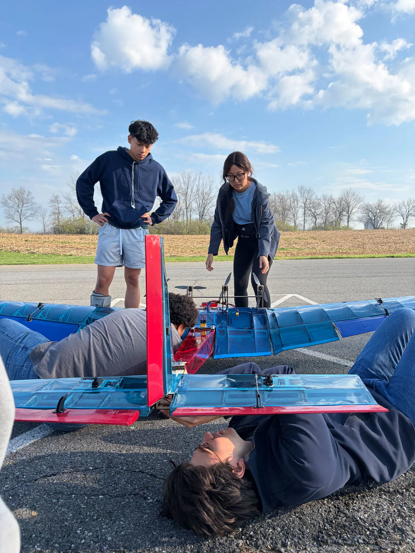 Penn Aerial Robotics team working around the assembled Leviathan aircraft outdoors.