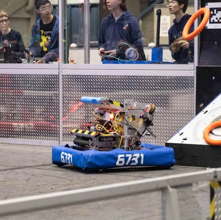 Maestro driving near an elevated scoring structure.